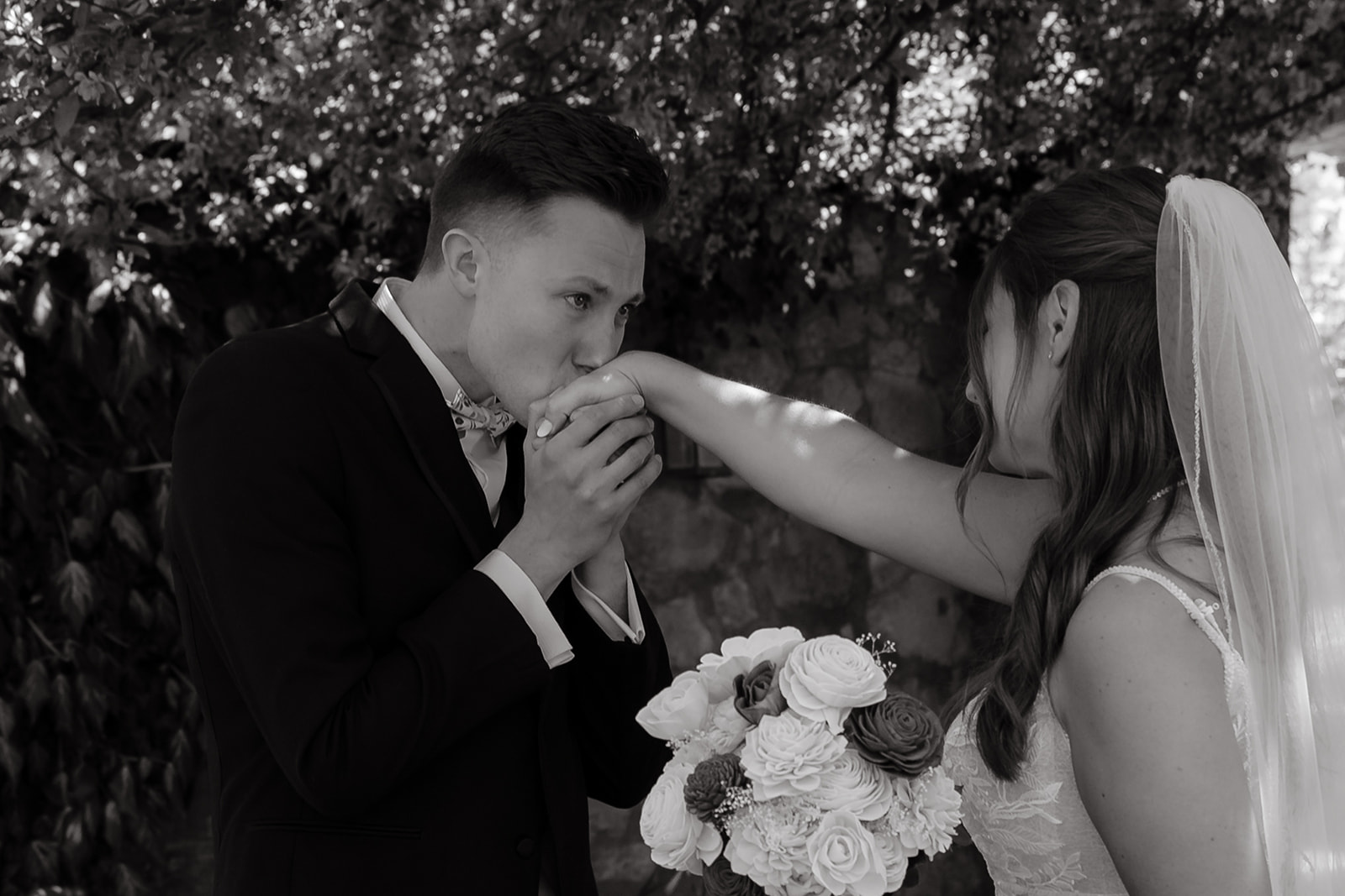 Groom kissing brides hand